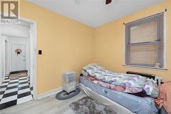 Bedroom with light wood-type flooring and ceiling fan - 