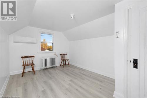 Bonus room featuring radiator heating unit, vaulted ceiling, light hardwood / wood-style flooring, and an AC wall unit - 349 Kipling Avenue, Etobicoke, ON - Indoor Photo Showing Other Room