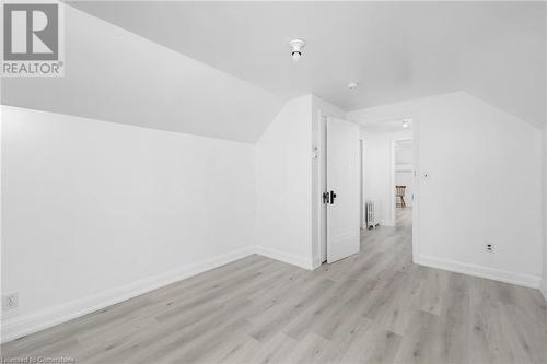 Additional living space with radiator heating unit, light hardwood / wood-style flooring, and vaulted ceiling - 349 Kipling Avenue, Etobicoke, ON - Indoor Photo Showing Other Room