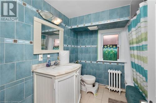 Bathroom with vanity, radiator, a shower with curtain, tile patterned flooring, and tile walls - 349 Kipling Avenue, Etobicoke, ON - Indoor Photo Showing Bathroom