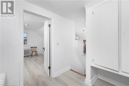 Hallway with radiator heating unit, light wood-type flooring, an AC wall unit, and lofted ceiling - 349 Kipling Avenue, Etobicoke, ON - Indoor Photo Showing Other Room