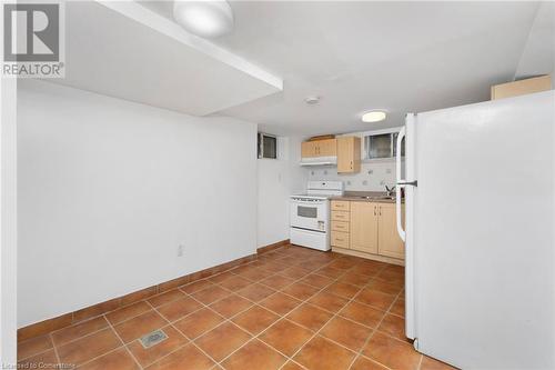 Kitchen featuring white appliances, tile patterned floors, sink, decorative backsplash, and light brown cabinetry - 349 Kipling Avenue, Etobicoke, ON - Indoor Photo Showing Kitchen