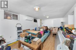 Bedroom featuring a wall mounted air conditioner and light wood-type flooring - 