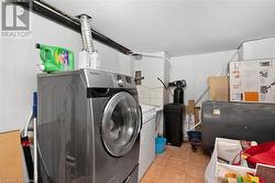 Washroom featuring washer and dryer and light tile patterned floors - 