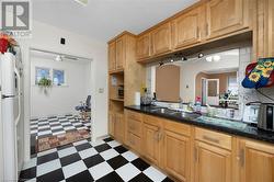 Kitchen featuring ceiling fan, sink, and white refrigerator - 