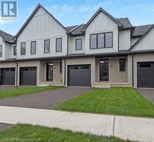 View of front facade with a front yard and a garage - 3C Balsam Street, Innerkip, ON - Outdoor With Facade