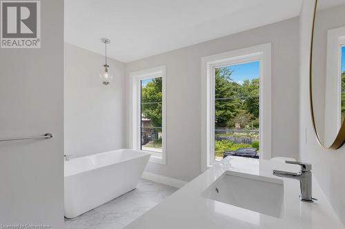 Bathroom with vanity, a wealth of natural light, and a bathing tub - 3C Balsam Street, Innerkip, ON - Indoor Photo Showing Bathroom