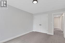 Unfurnished bedroom featuring light colored carpet and a closet - 