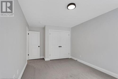 Unfurnished bedroom with light carpet and a closet - 3C Balsam Street, Innerkip, ON - Indoor Photo Showing Other Room