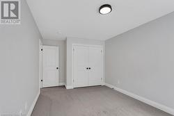 Unfurnished bedroom with light carpet and a closet - 