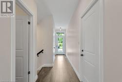 Hallway featuring wood-type flooring - 