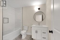 Full bathroom featuring vanity, toilet, and shower / washtub combination - 