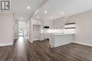 Kitchen featuring dark hardwood / wood-style floors, sink, white cabinetry, and kitchen peninsula - 3C Balsam Street, Innerkip, ON  - Indoor Photo Showing Kitchen 