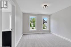 Unfurnished room featuring light carpet - 