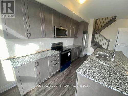 116 - 1565 Rose Way, Milton, ON - Indoor Photo Showing Kitchen With Double Sink