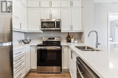 535 - 102 Grovewood Common, Oakville, ON - Indoor Photo Showing Kitchen With Stainless Steel Kitchen With Double Sink With Upgraded Kitchen