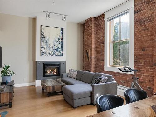 203-610 Johnson St, Victoria, BC - Indoor Photo Showing Living Room With Fireplace