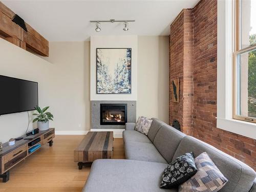 203-610 Johnson St, Victoria, BC - Indoor Photo Showing Living Room With Fireplace