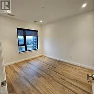 Unfurnished room with hardwood / wood-style flooring - 