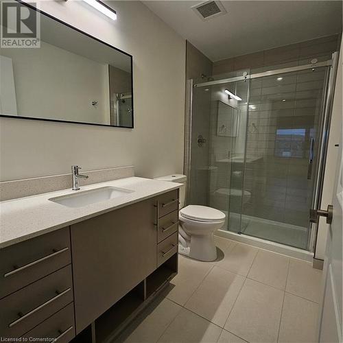 Bathroom featuring tile patterned floors, walk in shower, vanity, and toilet - 525 New Dundee Road Unit# 602, Kitchener, ON - Indoor Photo Showing Bathroom