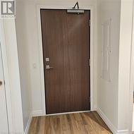 Entryway featuring electric panel and hardwood / wood-style flooring - 