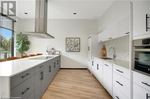 Kitchen featuring gray cabinetry, extractor fan, sink, white cabinets, and oven - 525 New Dundee Road Unit# 602, Kitchener, ON - Indoor Photo Showing Kitchen With Upgraded Kitchen