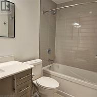 Full bathroom featuring vanity, toilet, and tiled shower / bath - 