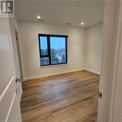 Empty room featuring wood-type flooring - 525 New Dundee Road Unit# 602, Kitchener, ON - Indoor Photo Showing Other Room