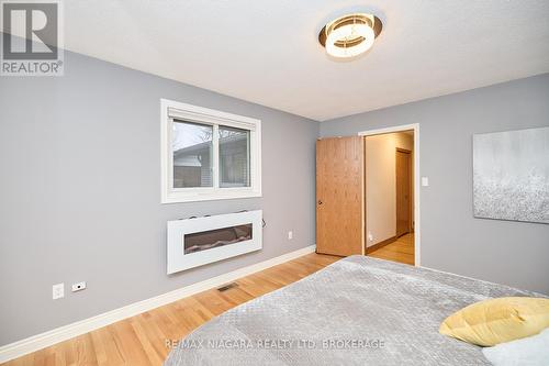 27 Walts Street, Welland (769 - Prince Charles), ON - Indoor Photo Showing Bedroom With Fireplace