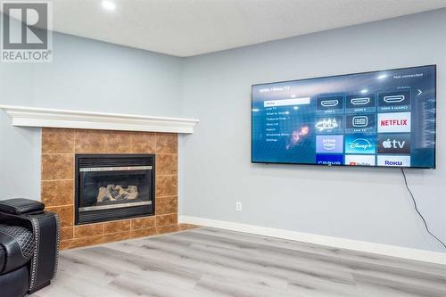 129 Lakeview Inlet, Chestermere, AB - Indoor Photo Showing Living Room With Fireplace