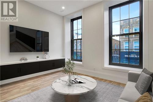 Living room with light hardwood / wood-style floors - 29 Main Street Unit# 201, Cambridge, ON - Indoor Photo Showing Living Room