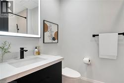 Bathroom with a shower, vanity, and toilet - 