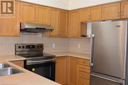 Kitchen with backsplash and appliances with stainless steel finishes - 