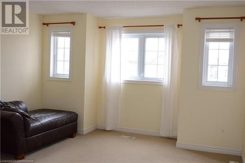 Sitting room with light colored carpet and a wealth of natural light - 157 Cranbrook Street, Kitchener, ON - Indoor