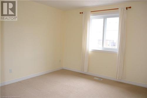 Empty room featuring carpet flooring and plenty of natural light - 157 Cranbrook Street, Kitchener, ON - Indoor Photo Showing Other Room