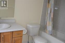 Full bathroom with shower / tub combo, vanity, and toilet - 