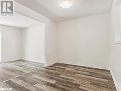 Unfurnished room with dark wood-type flooring and a textured ceiling - 