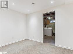 Empty room with carpet floors and washer and clothes dryer - 