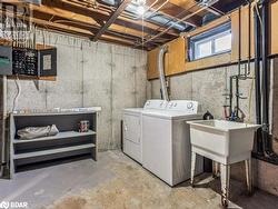 Washroom featuring electric panel, sink, and independent washer and dryer - 