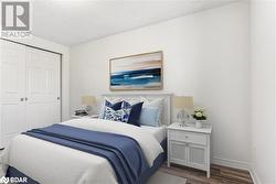 Bedroom featuring a textured ceiling, hardwood / wood-style flooring, and a closet - 