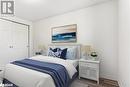 Bedroom featuring a textured ceiling, hardwood / wood-style flooring, and a closet - 242 Lakeport Road Unit# 22, St. Catharines, ON  - Indoor Photo Showing Bedroom 