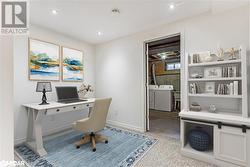 Home office featuring separate washer and dryer and light colored carpet - 