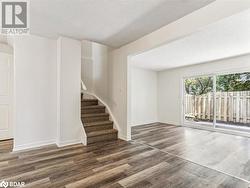 Spare room featuring dark hardwood / wood-style floors and a textured ceiling - 