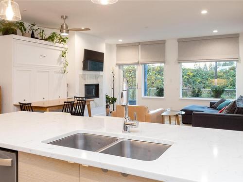 205-10670 Mcdonald Park Rd, North Saanich, BC - Indoor Photo Showing Kitchen With Fireplace With Double Sink