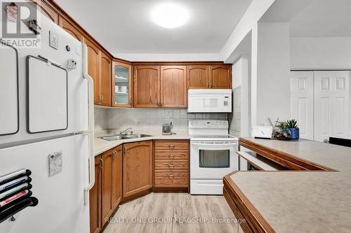 702 - 293 Mohawk Road E, Hamilton, ON - Indoor Photo Showing Kitchen With Double Sink