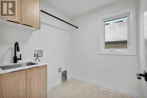 Stainless laundry sink, black pull-down faucet. - 1238 Whetherfield Street, London, ON - Indoor Photo Showing Other Room