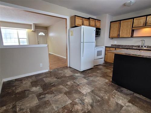 104 1 Street, Oakville, MB - Indoor Photo Showing Kitchen With Double Sink