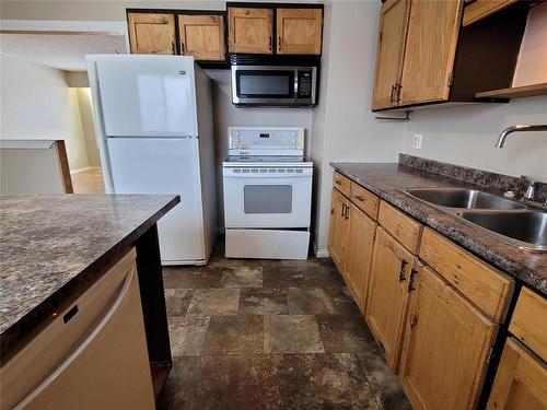 104 1 Street, Oakville, MB - Indoor Photo Showing Kitchen With Double Sink