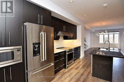 123 - 1890 Rymal Road E, Hamilton, ON - Indoor Photo Showing Kitchen With Double Sink With Upgraded Kitchen