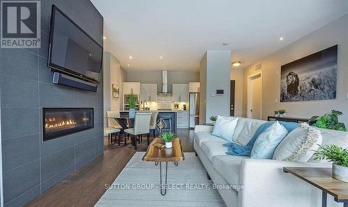 100 - 1705 Fiddlehead Place, London, ON - Indoor Photo Showing Living Room With Fireplace